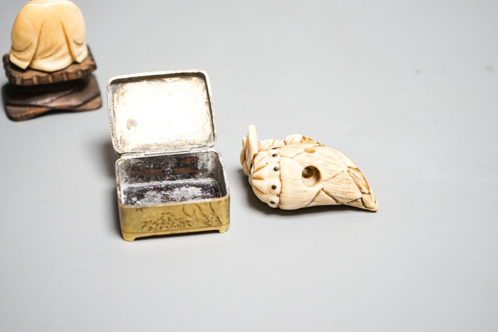 19th-century Japanese Ivory netsuke a man on a bamboo shoot, an ivory figure of Budai and a Japanese embossed brass box 5cm